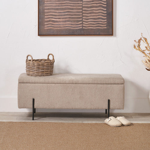 Beige storage bench with a woven basket on top in a room setting.
