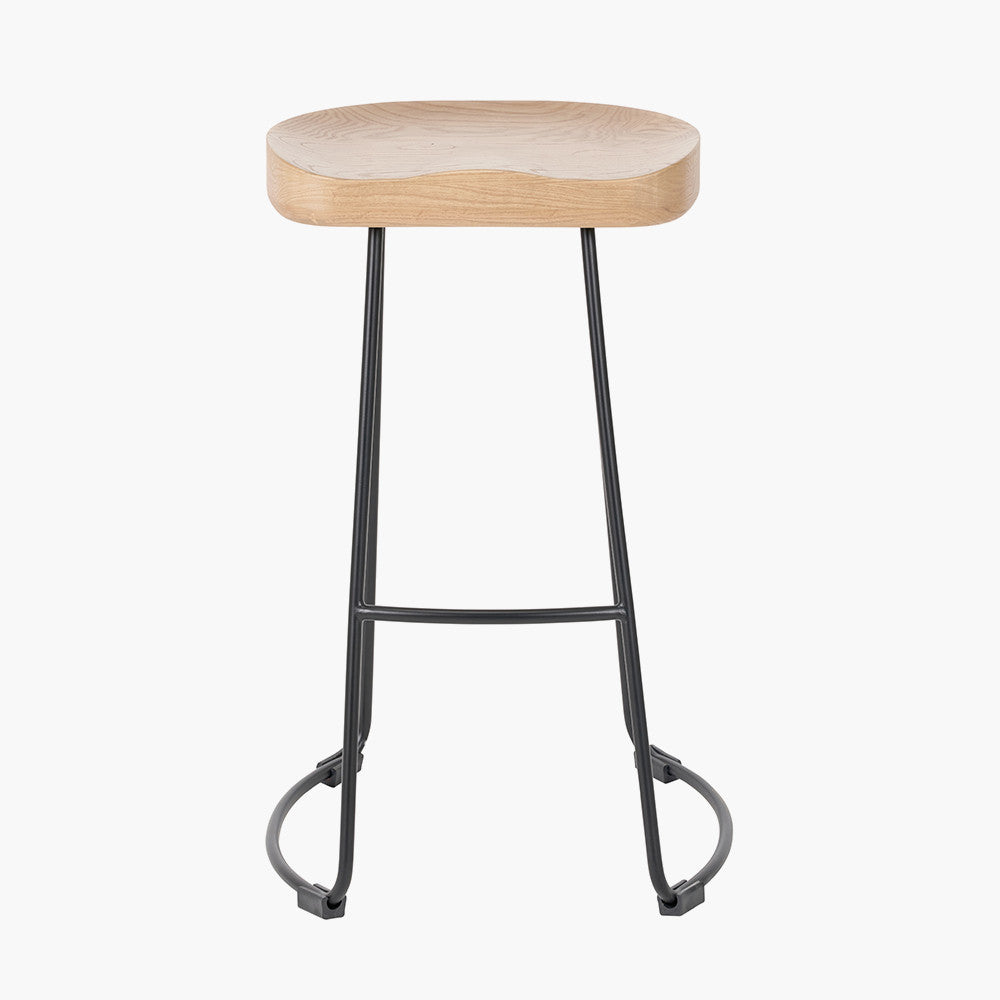 Enhance your seating area with this minimalist bar stool featuring a solid ash wood seat paired with black metal legs, creating a striking contrast that suits contemporary interiors. Shop online today at www.nobleandnook.co.uk