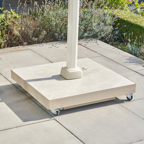 Concrete patio umbrella stand on wheels with garden background