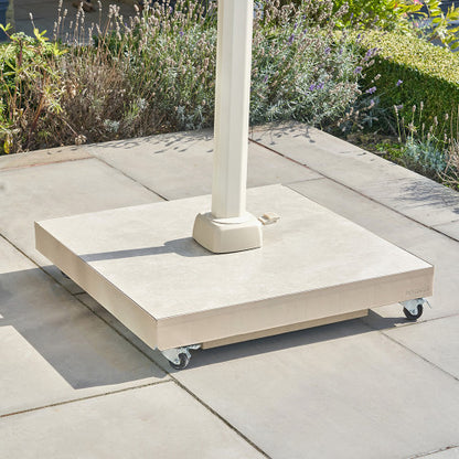 Concrete patio umbrella stand on wheels with garden background