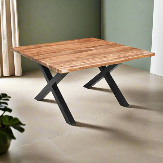 The Live Edge Large Square Dining Table is crafted from solid Acacia wood with a striking live edge and black powder-coated steel legs to add an industrial edge. L140 x W140 x H76 cm. www.nobleandnook.co.uk