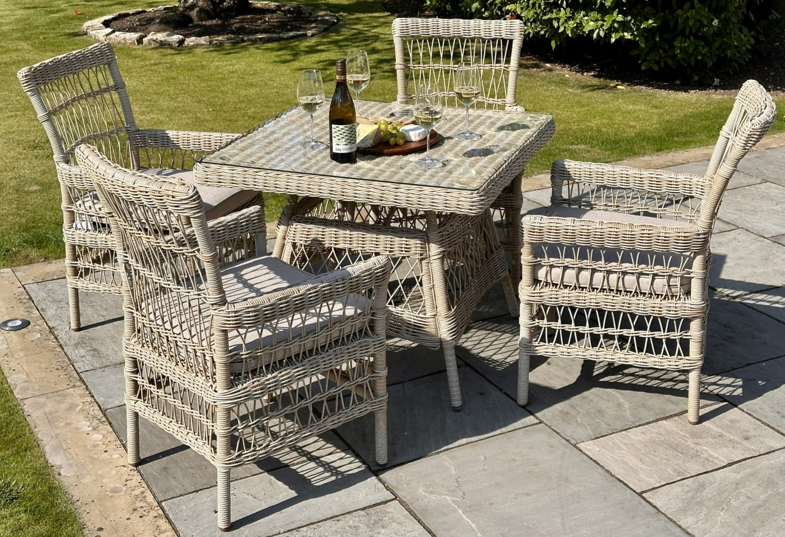 Wicker outdoor dining set with table and chairs on a patio