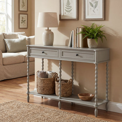 Grey console table in a living room with decor items