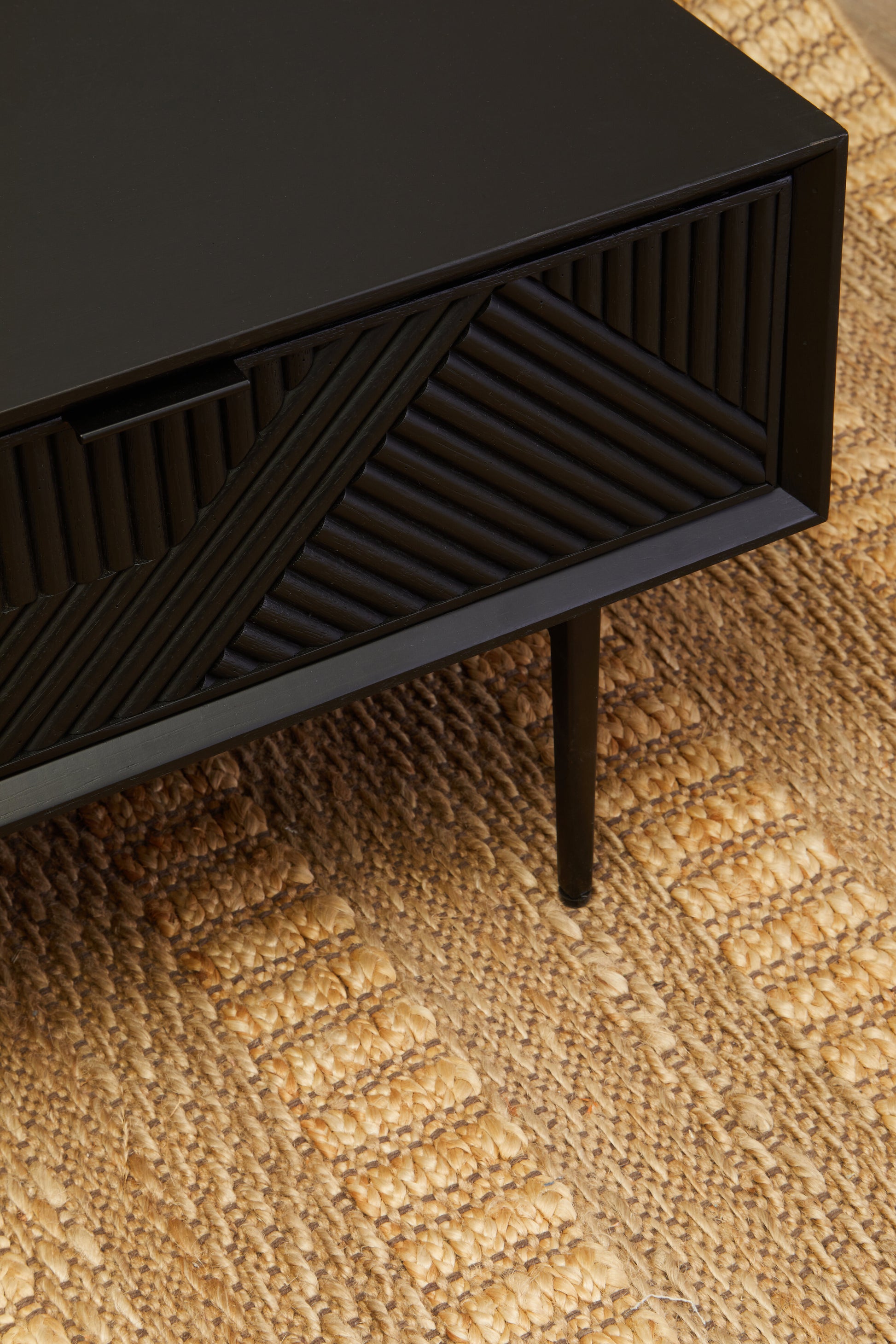 The Kajara Coffee Table pairs black carved wood finish with clean black metal legs, offering an elegant balance between rustic charm and modern minimalism. Shop online today at www.nobleandnook.co.uk