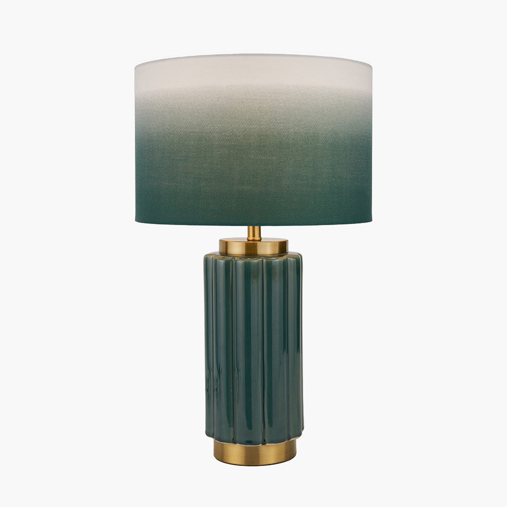 Table lamp with green gradient shade and gold base on a white background