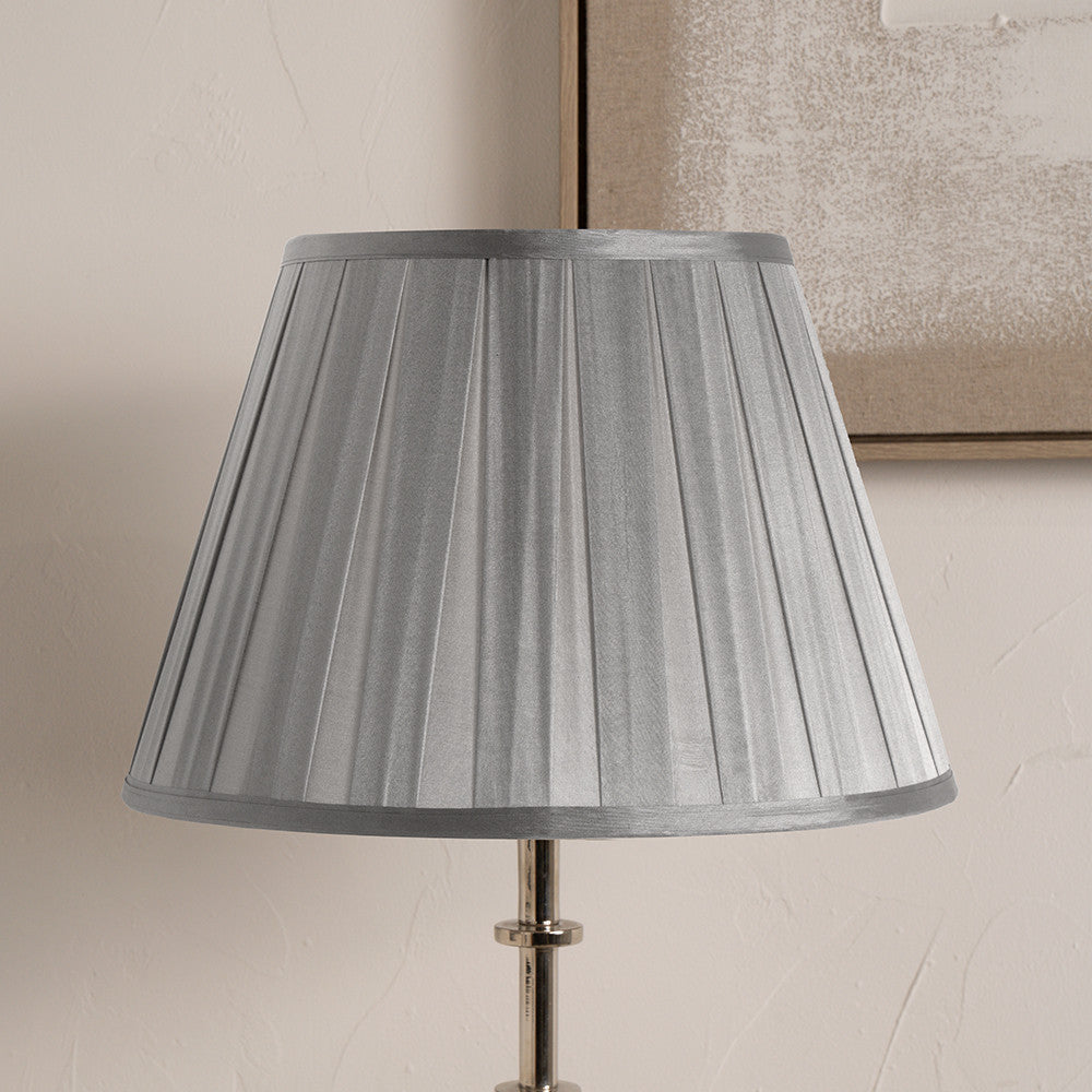 Gray pleated lampshade on a neutral background
