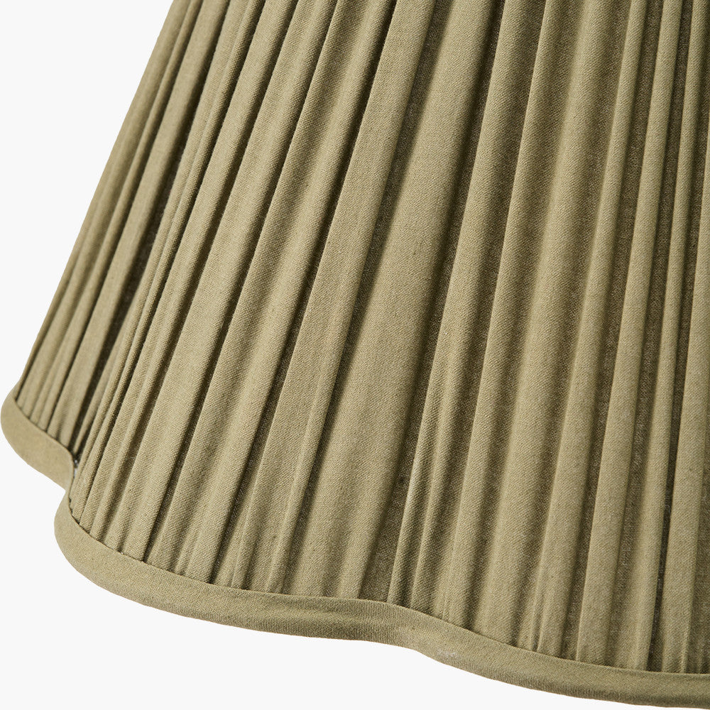 Close-up of a pleated beige lampshade on a white background