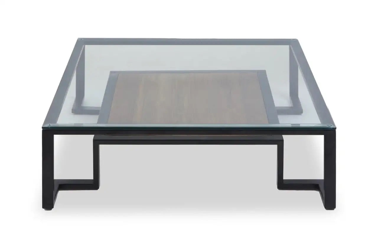 Featuring a refined balance of materials, its clear glass top is perfectly framed by a black metal structure, complemented by a warm teak wood shelf below. Shop online today at www.nobleandnook.co.uk