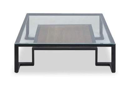 Featuring a refined balance of materials, its clear glass top is perfectly framed by a black metal structure, complemented by a warm teak wood shelf below. Shop online today at www.nobleandnook.co.uk