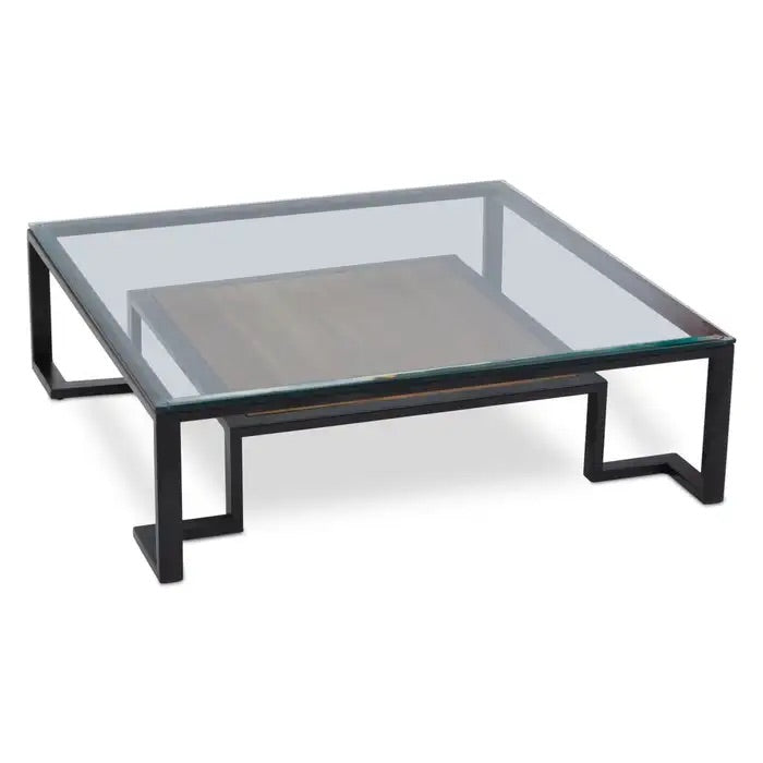 Featuring a refined balance of materials, its clear glass top is perfectly framed by a black metal structure, complemented by a warm teak wood shelf below. Shop online today at www.nobleandnook.co.uk