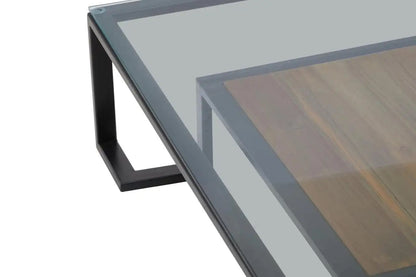 Featuring a refined balance of materials, its clear glass top is perfectly framed by a black metal structure, complemented by a warm teak wood shelf below. Shop online today at www.nobleandnook.co.uk