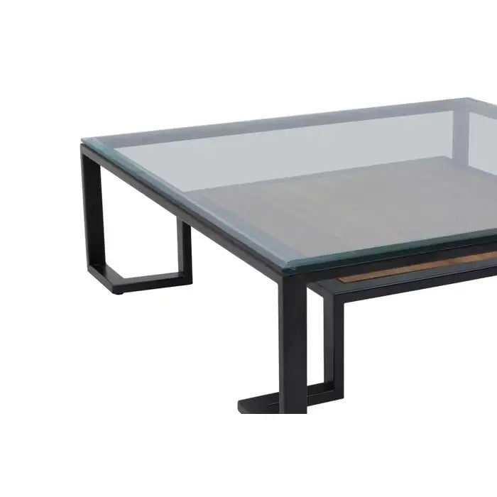 Featuring a refined balance of materials, its clear glass top is perfectly framed by a black metal structure, complemented by a warm teak wood shelf below. Shop online today at www.nobleandnook.co.uk
