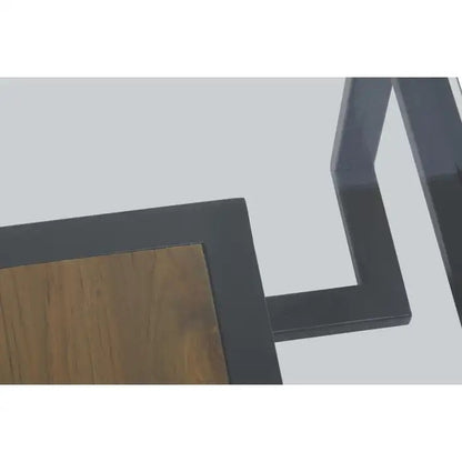 Featuring a refined balance of materials, its clear glass top is perfectly framed by a black metal structure, complemented by a warm teak wood shelf below. Shop online today at www.nobleandnook.co.uk