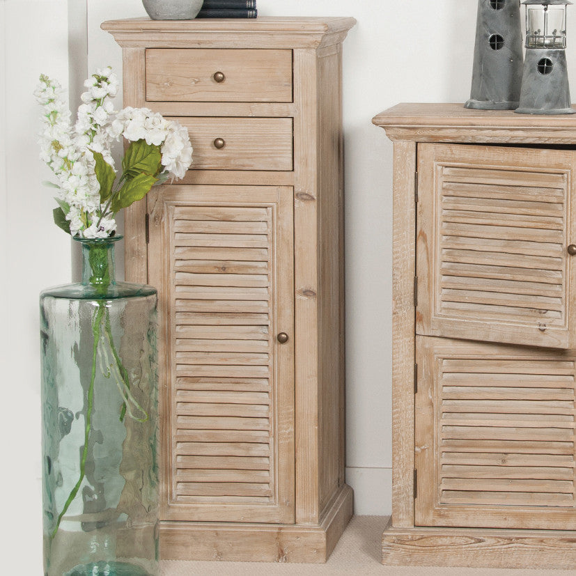 Two wooden cabinets with a vase of flowers and decorative items on a white background