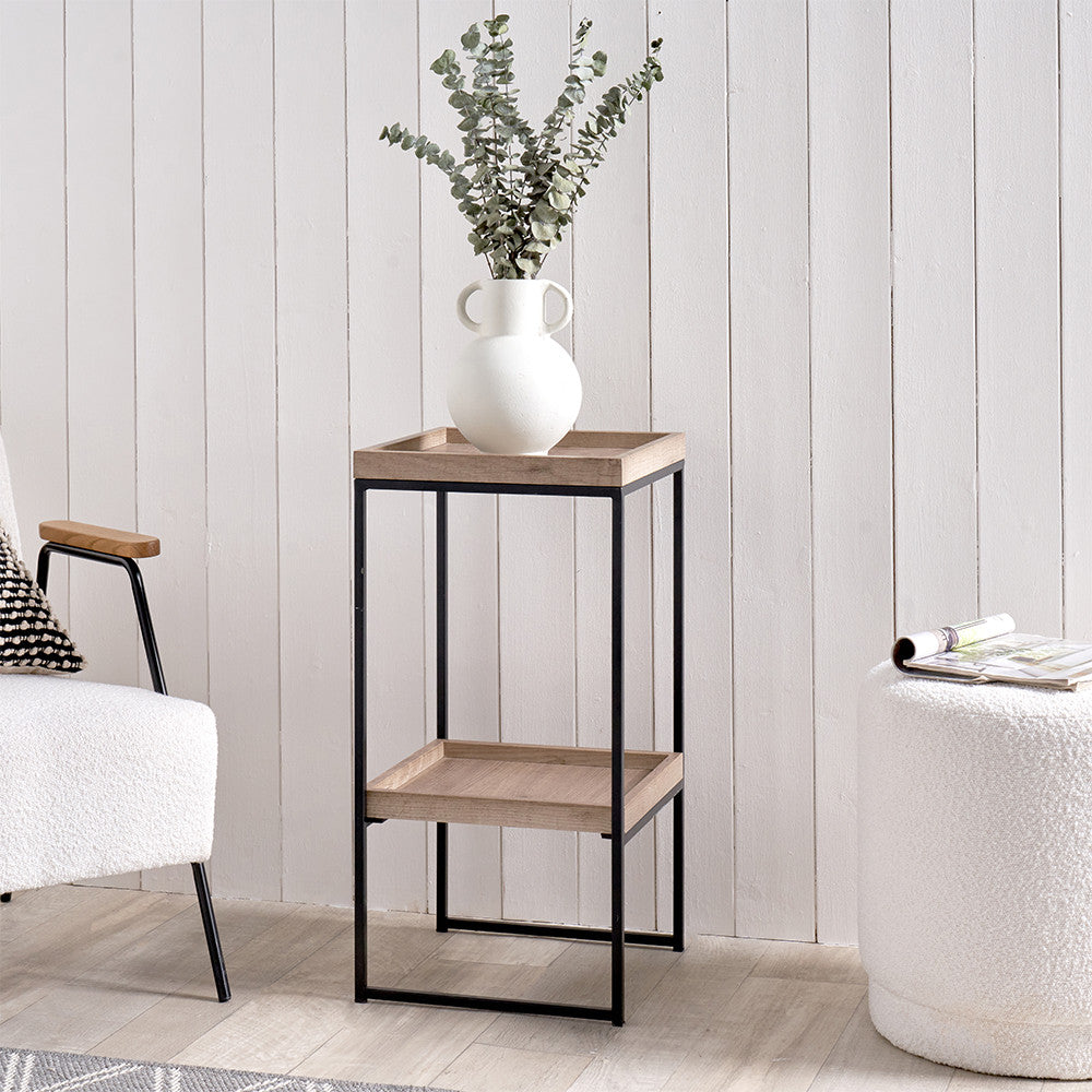 The Gallery Natural Wood Veneer and Black Metal Side Table adds a modern charm and functionality to your living space. W35xD35xH70cm. Available at www.nobleandnook.co.uk