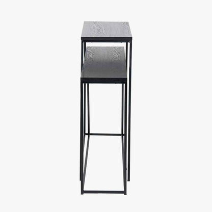 Add bold style and adaptability to your home with the Mashiko Black Ash Veneer and Black Metal Console Tables. Set of two versatile tables with sleek black ash veneer tops. Shop online today at www.nobleandnook.co.uk