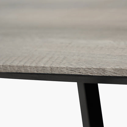 Ukiah Grey Oak Veneer and Black Metal Dining Table, featuring a grey oak veneer top with soft, rounded edges, paired with sturdy black metal legs. W180xD91xH76cm. Available at www.nobelandnook.co.uk