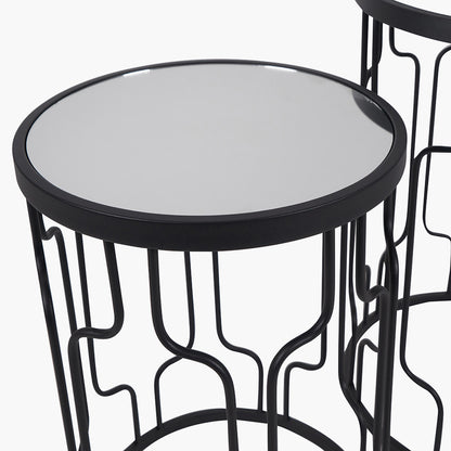 Set of Two Elegant Art Deco Design Side Tables – Includes one large and one small table for versatile styling. Black metal frames with circular silhouettes and mirrored glass tops. Available at www.nobleandnook.co.uk
