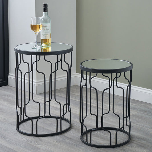 Set of Two Elegant Art Deco Design Side Tables – Includes one large and one small table for versatile styling. Black metal frames with circular silhouettes and mirrored glass tops. Available at www.nobleandnook.co.uk