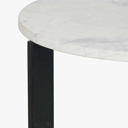 This striking Side Table pairs a luxurious marble top with gracefully curved black metal legs, creating a sophisticated contrast of texture and form. Dimensions W46xD46xH56cm. Shop online today at www.nobleandnook.co.uk