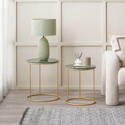 Two marble top side tables with gold metal frames in a living room setting.