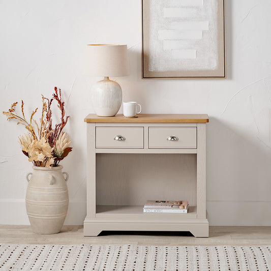 Add timeless country cottage charm to your home with the Fairford 2-Drawer Console Table. Crafted from pine wood with a parchment-white finish and oak-effect top, this elegant table offers practical storage and arrives fully assembled.