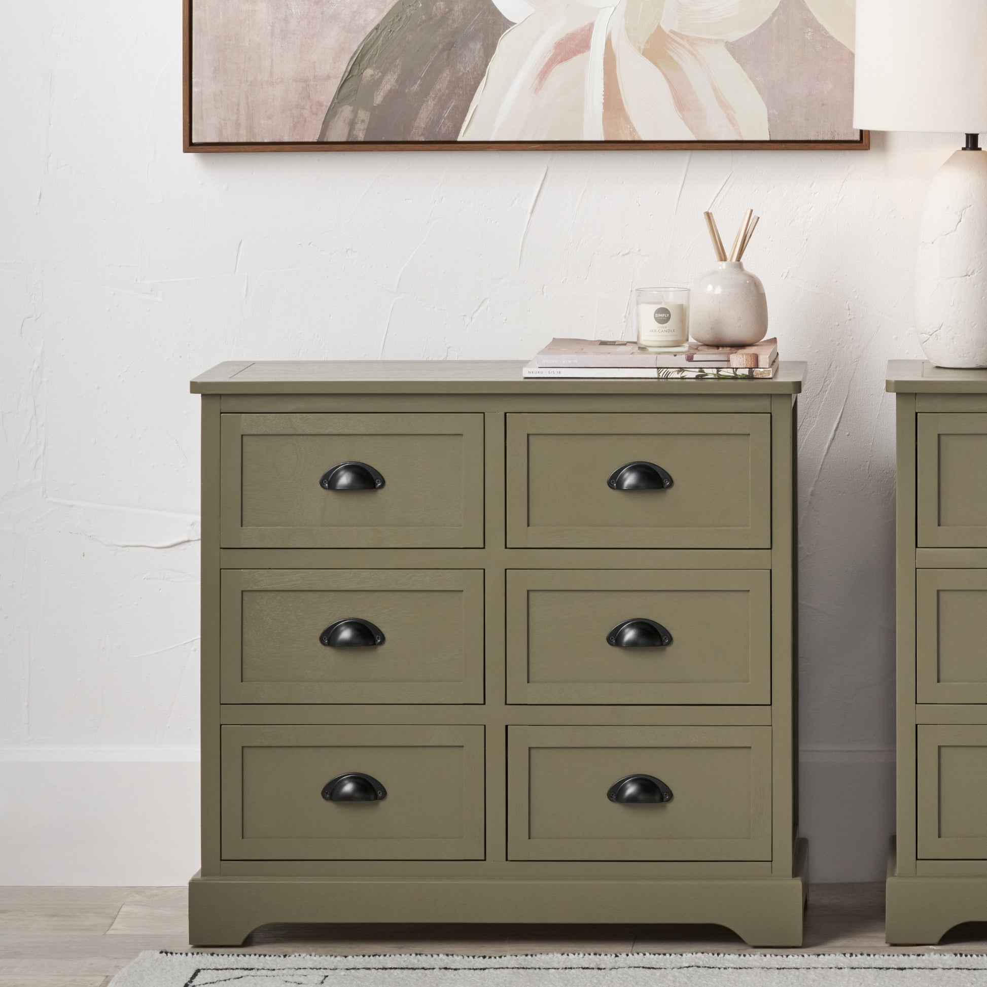 Green dresser with four drawers in a room setting