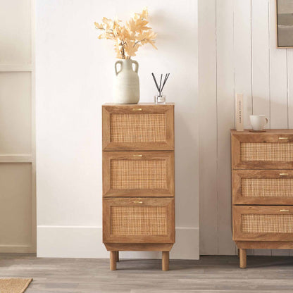 Wooden cabinet with wicker drawers against a white wall