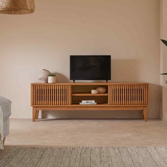 Wooden TV stand with a television in a living room setting.