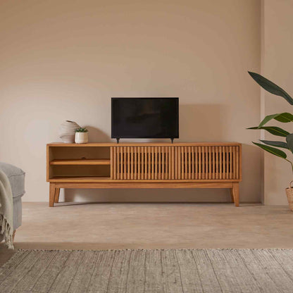 Wooden TV stand with a television in a minimalistic living room.