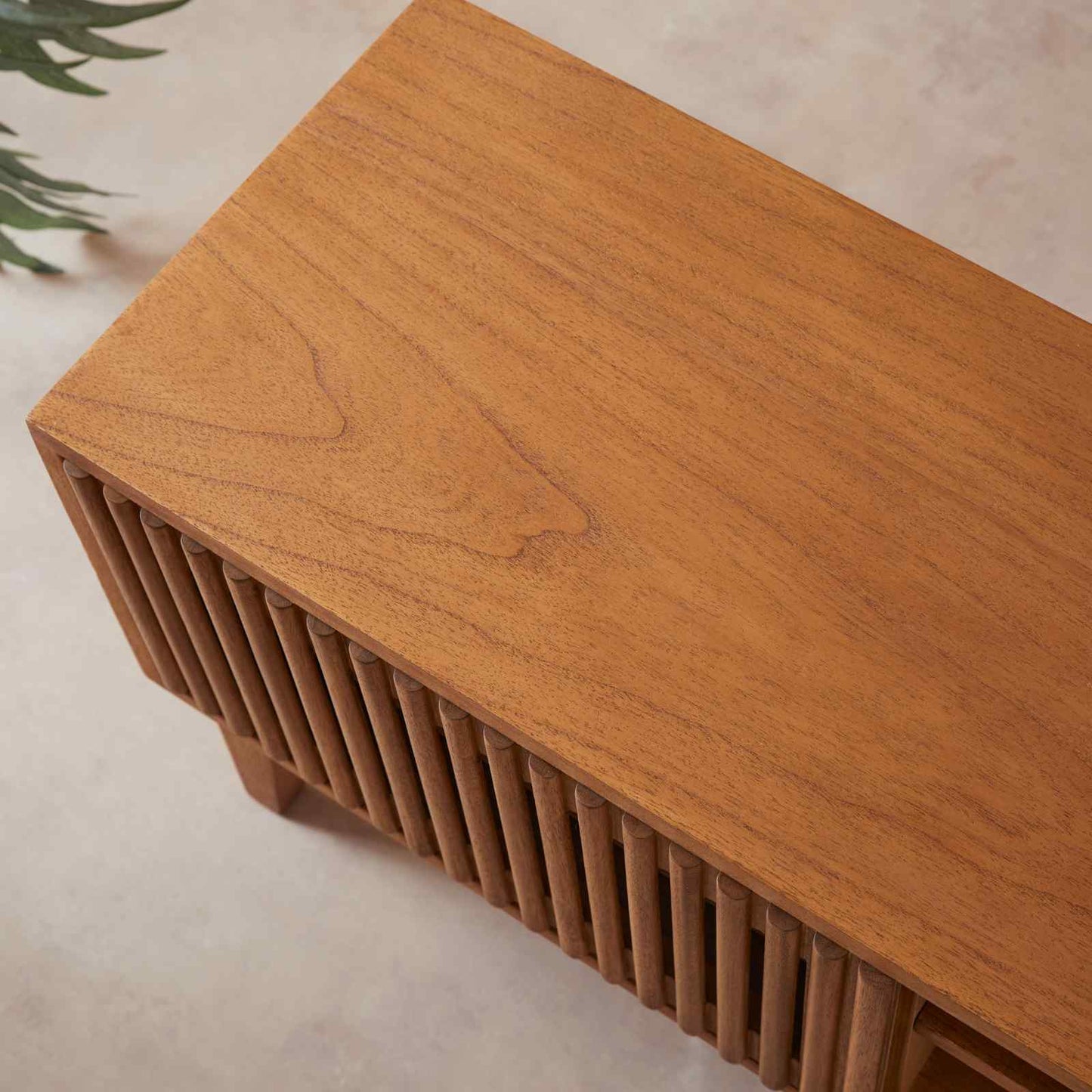 Wooden bench with slatted design on a light background