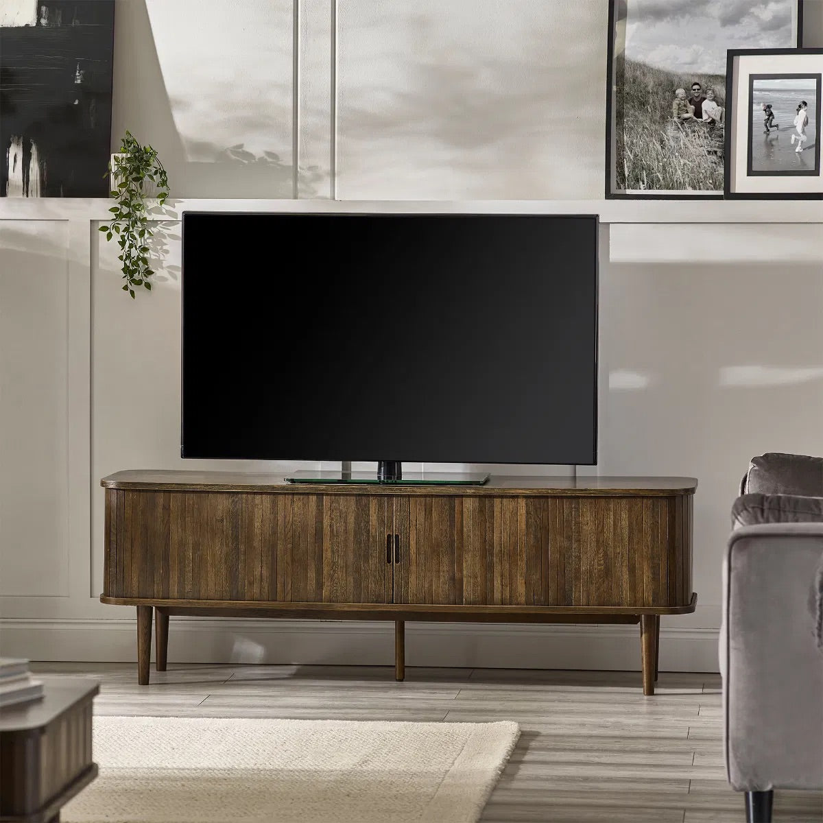 Elevate your living room with the Arya TV Media Unit in refined dark oak effect finish with sliding slatted doors. Perfect for modern homes. Shop online today at www.nobleandnook.co.uk