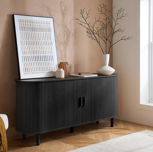 Elevate your interior with this 2 Door Fluted Sideboard, blending contemporary elegance with practical design and black finish adds sophistication to any room. Shop online at www.nobleandnook.co.uk