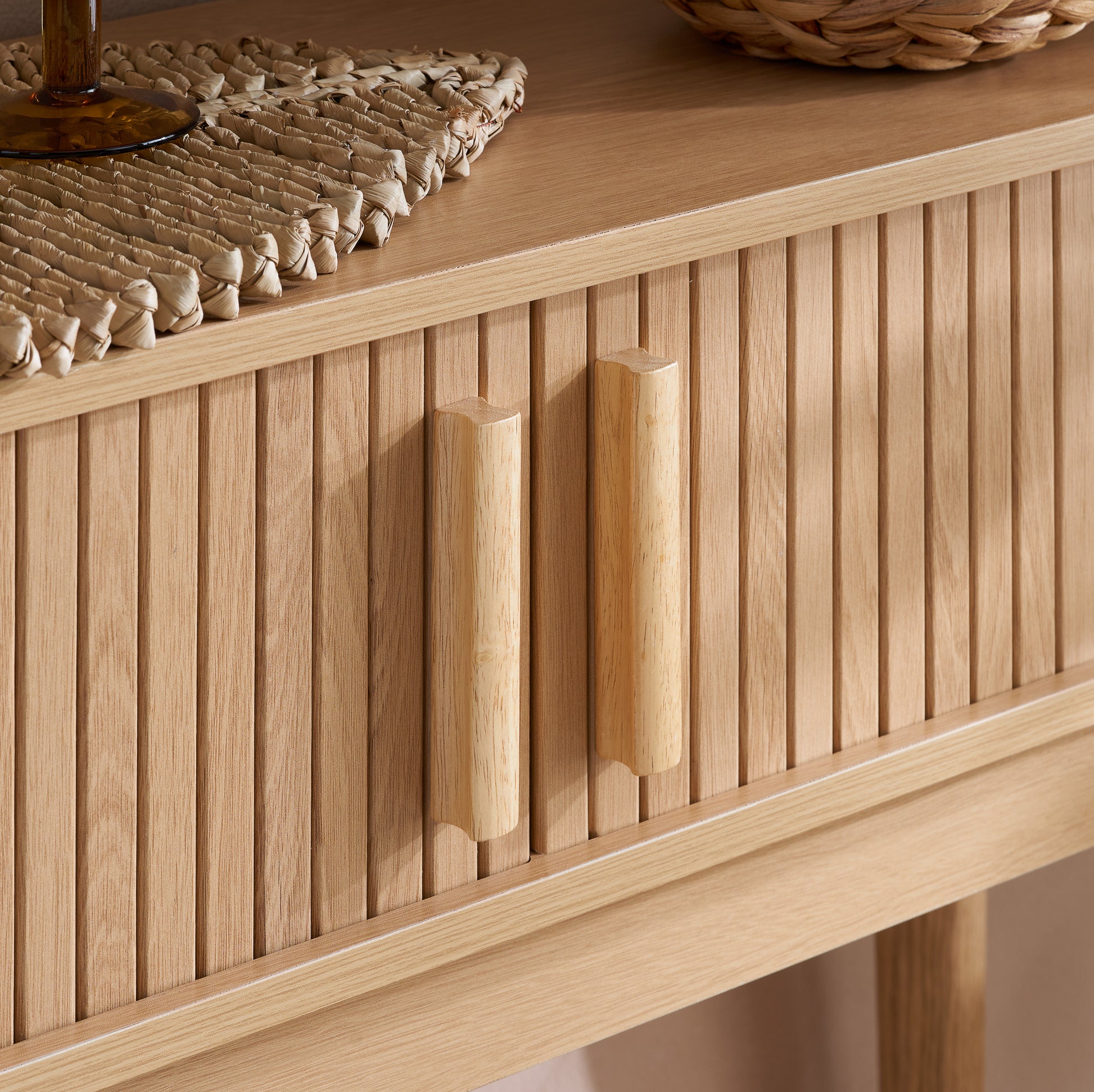 Elevate your interior with the Axel Console Table in an Oak Finish. This stylish table features exquisite fluted detailing, adds depth and sophistication to any living space. Shop online today at www.nobleandnook.co.uk