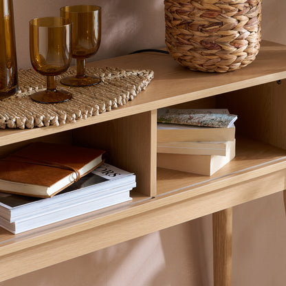Elevate your interior with the Axel Console Table in an Oak Finish. This stylish table features exquisite fluted detailing, adds depth and sophistication to any living space. Shop online today at www.nobleandnook.co.uk