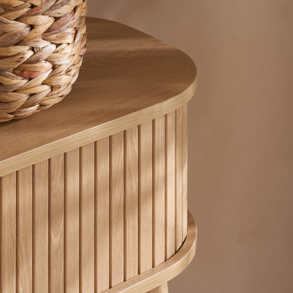 Elevate your interior with the Axel Console Table in an Oak Finish. This stylish table features exquisite fluted detailing, adds depth and sophistication to any living space. Shop online today at www.nobleandnook.co.uk