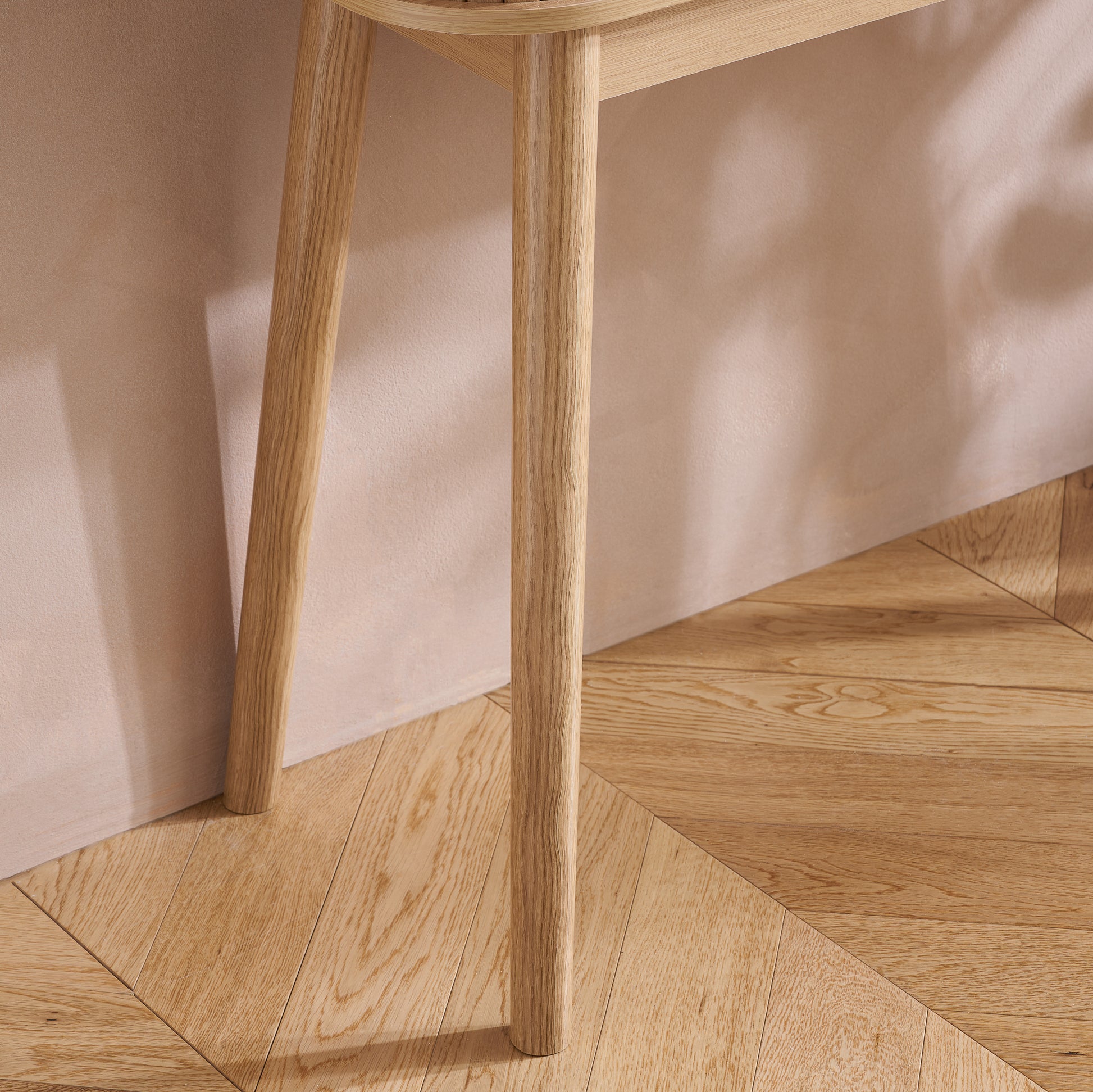 Elevate your interior with the Axel Console Table in an Oak Finish. This stylish table features exquisite fluted detailing, adds depth and sophistication to any living space. Shop online today at www.nobleandnook.co.uk