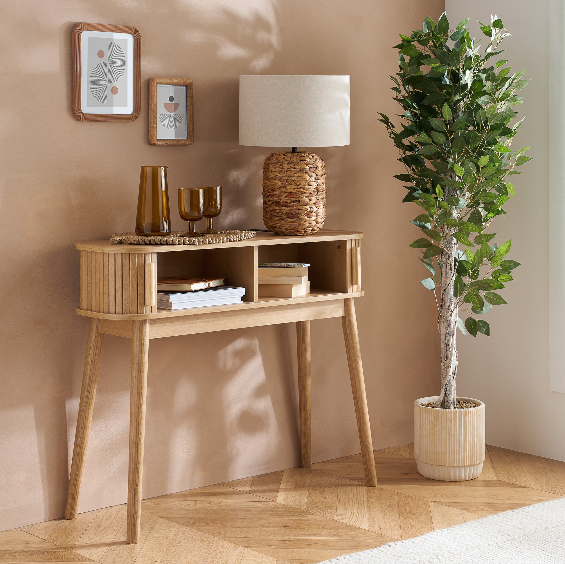 Elevate your interior with the Axel Console Table in an Oak Finish. This stylish table features exquisite fluted detailing, adds depth and sophistication to any living space. Shop online today at www.nobleandnook.co.uk