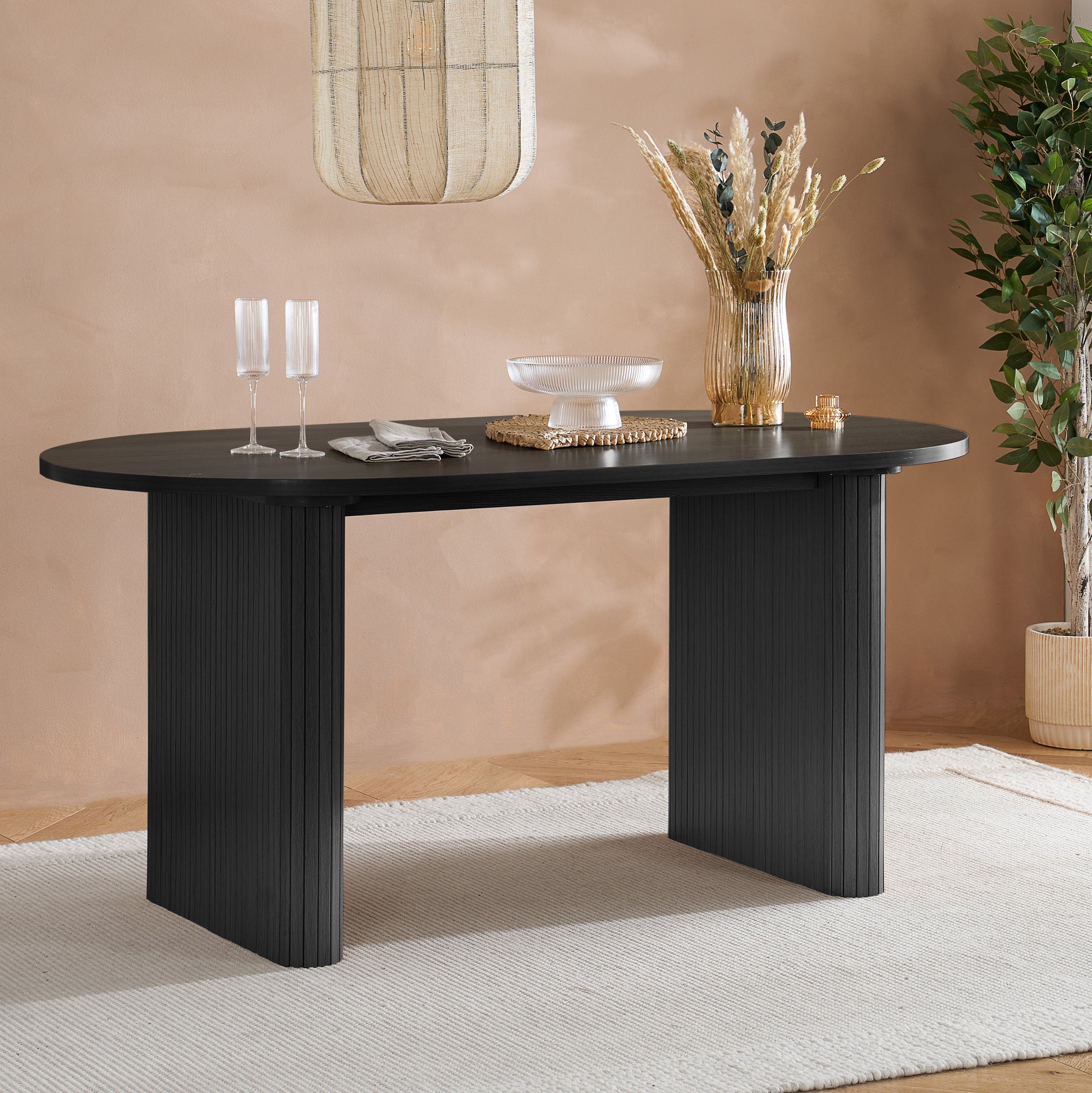 Crafted from premium MDF and available in two stylish finishes, oak or black, this oval table features beautiful fluted detailing that creates a modern, refined look. Shop online today at www.nobleandnook.co.uk
