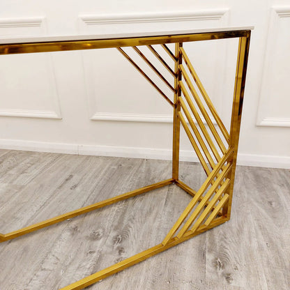 Shop now to redefine your interior design with the Azure Console Table. Featuring a gold tone frame with a Polar White Sintered Stone top. Perfectly suited for entrances and hallways. Shop online today at www.nobleandnook.co.uk