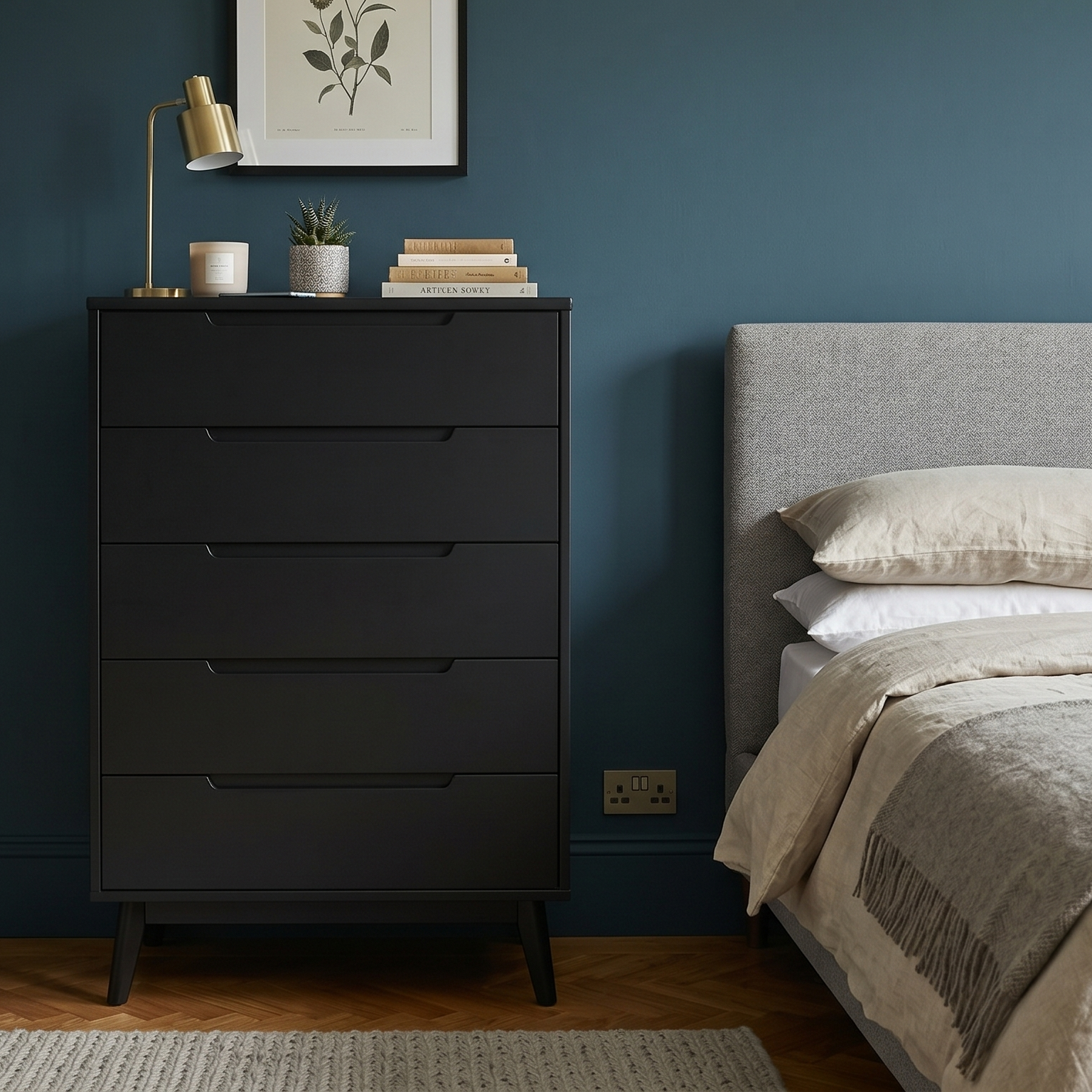Bedroom with a black dresser against a blue wall