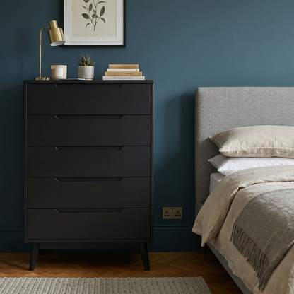 Bedroom with a black dresser against a blue wall