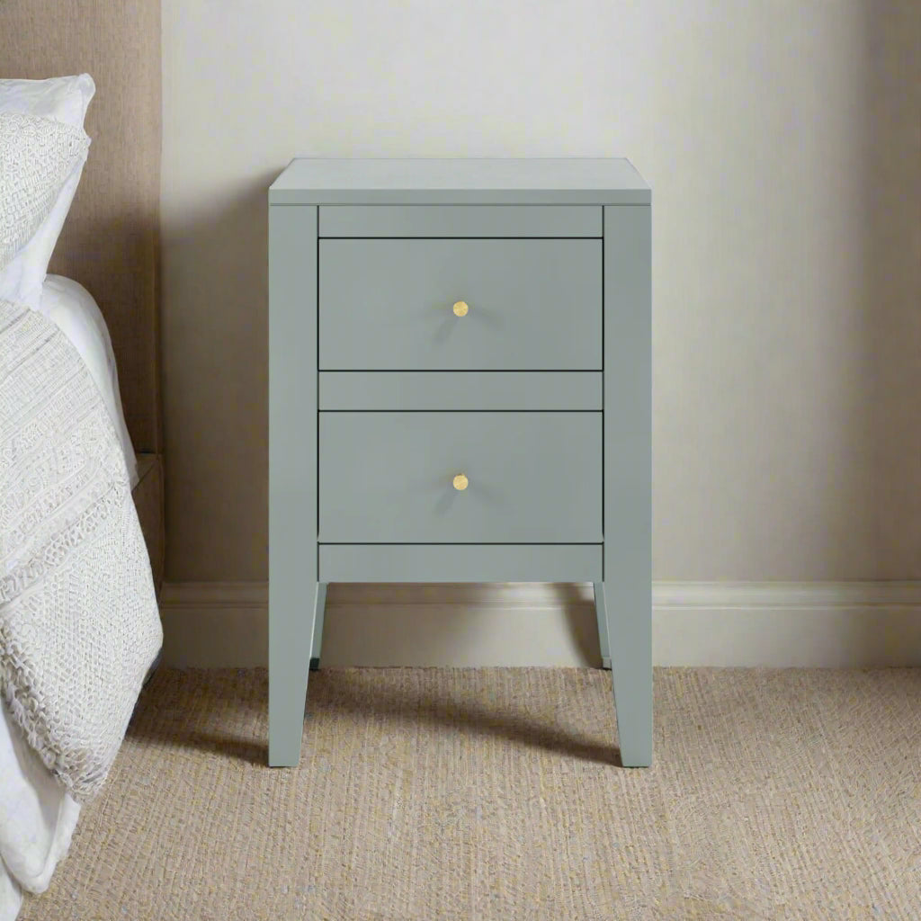 Shop this sophisticated two-drawer bedside table, featuring a chic pigeon grey finish and elegant brass-style handles. Shop online today at www.nobleandnook.co.uk