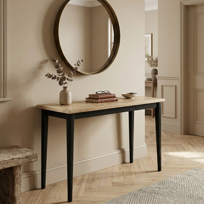 Wooden console table with round mirror above in a room with wooden floor and neutral walls.