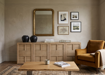 Living room with wooden sideboard, armchair, and coffee table.