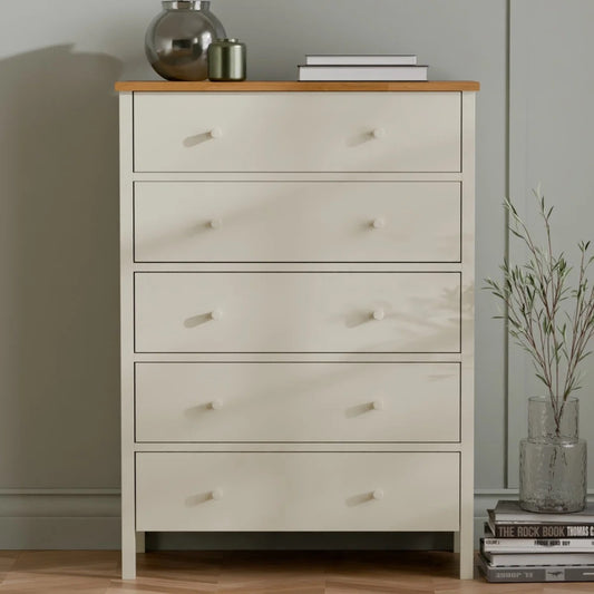 White dresser with wooden top against a neutral wall
