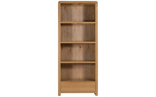 The Curve Tall Solid Oak Bookcase, a stylish and practical addition to any modern home. Its clean lines and gently curved edging bring a touch of retro charm to your living or dining space. Shop online at www.nobleandnook.co.uk