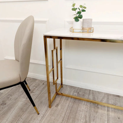 Add instant glamour to your home with this Console Table, featuring a bold, squared geometric frame in a radiant gold finish and a sleek Polar White Sintered Stone top. Shop online today at www.nobleandnook.co.uk