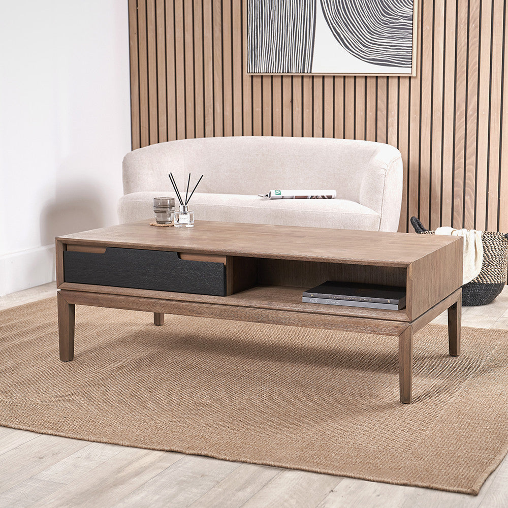 Wooden coffee table with decorative items in a living room setting