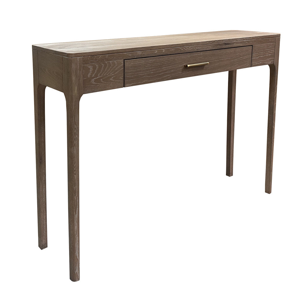 A modern console table with a medium brown wood finish, featuring a single drawer with a slim brass pull handle, on a solid white background.